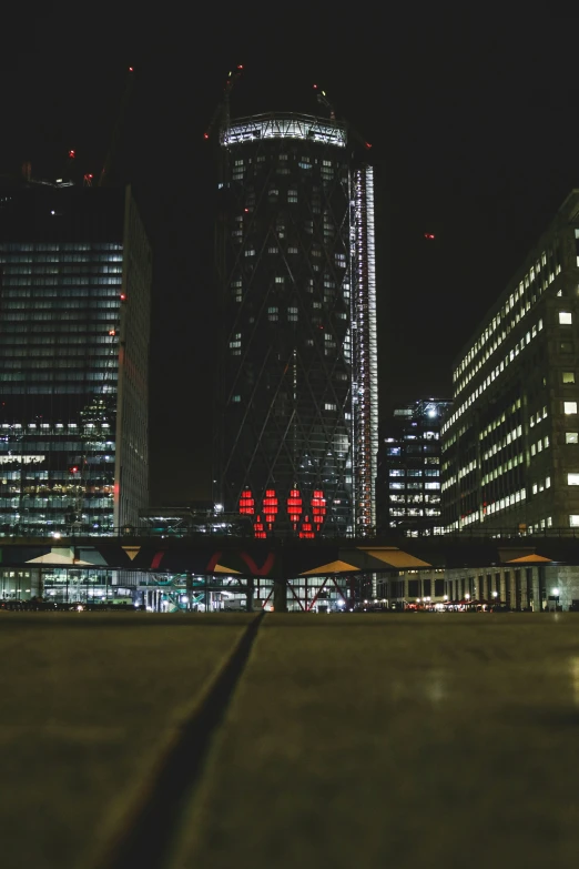 a night time view of some very tall buildings