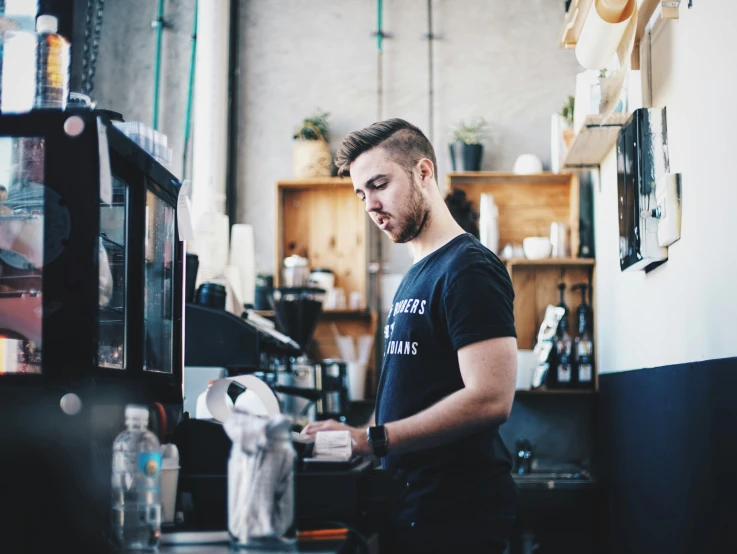 a man working in a kitchen making soing