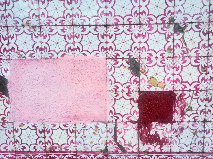 colorful tile with red paint and a pink square on it