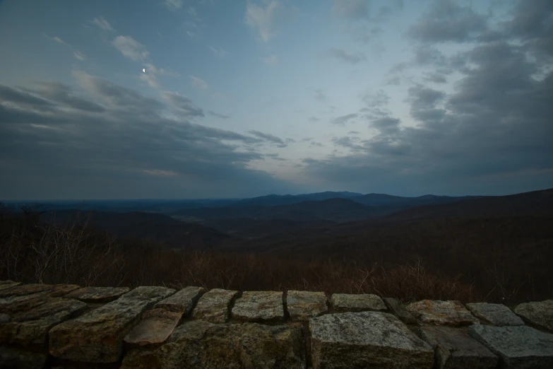 the view from above of rocks on top of a hill