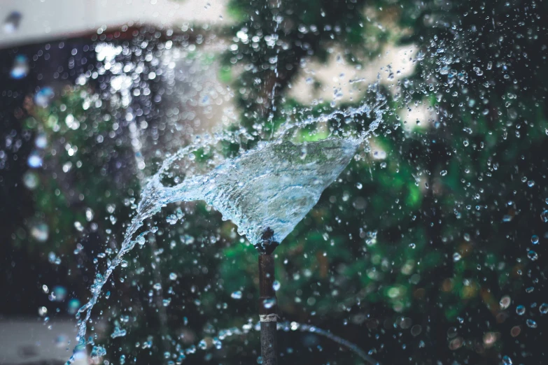 an umbrella is covered by water that has bursting