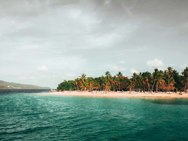 people are relaxing on a tropical beach near the ocean