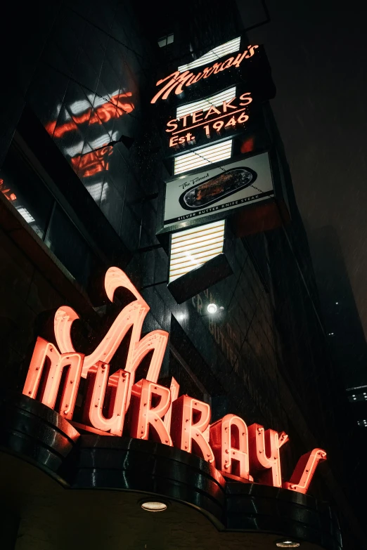 a neon sign for an alleyway on the side of the street
