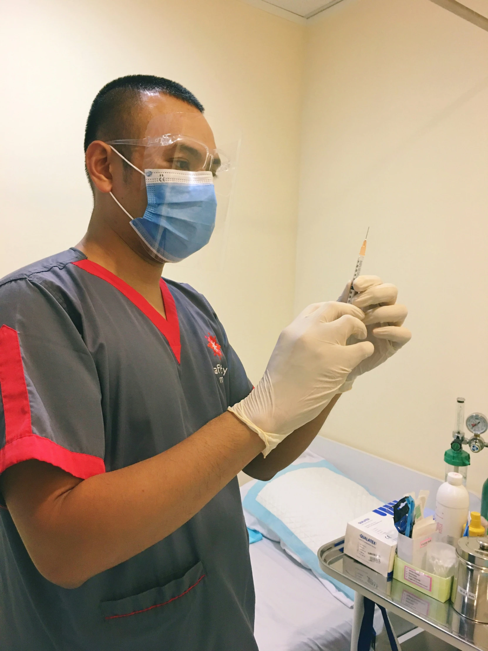 a medical person holding a needle in their hand