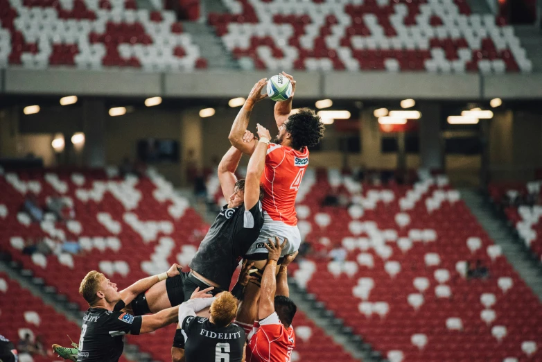 two rugby teams are competing for the ball