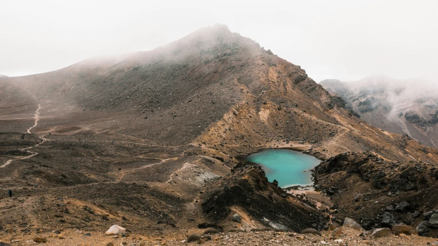 a beautiful mountain scene has a lake in the center