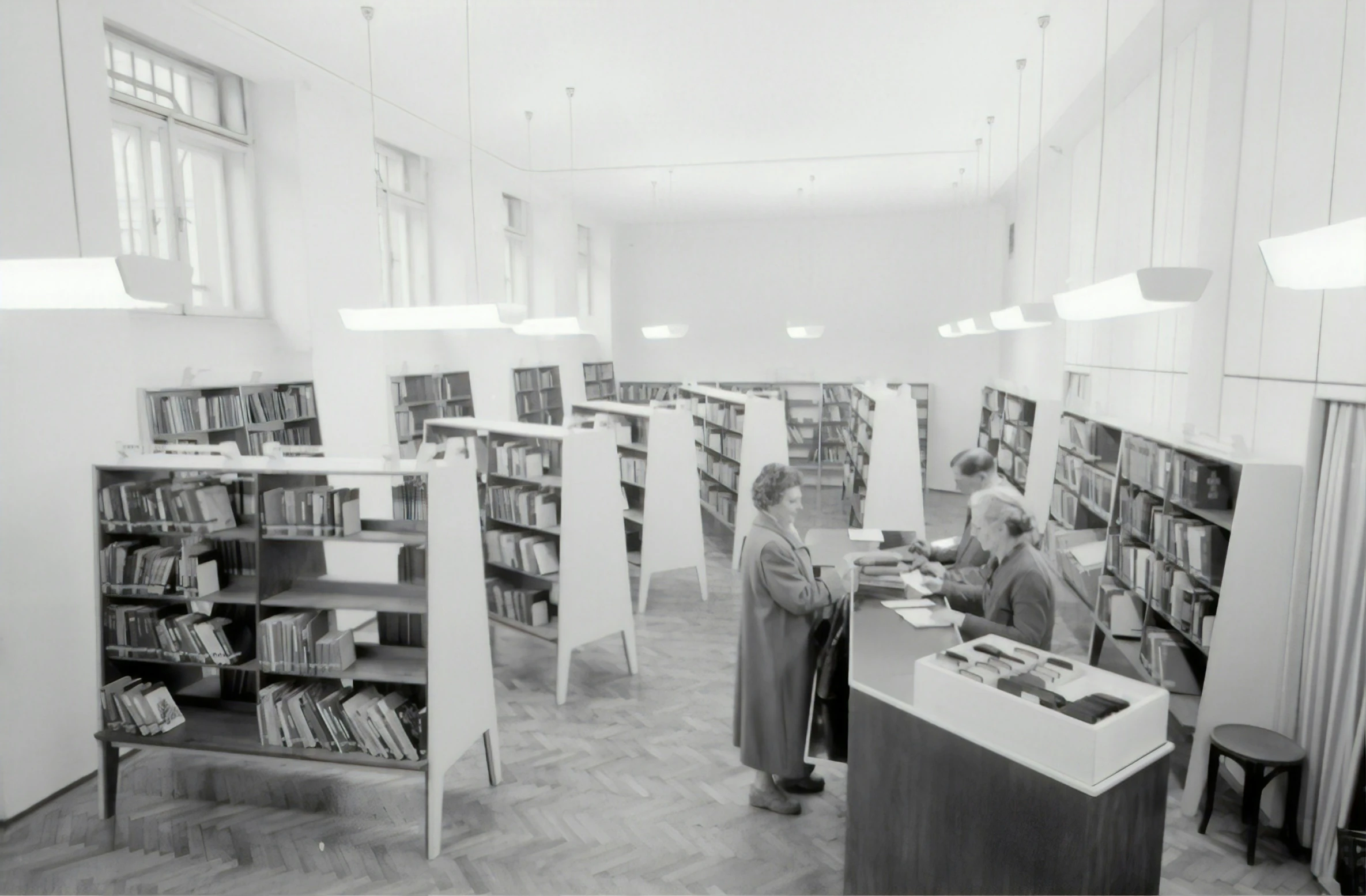 a liry with people working in the stacks