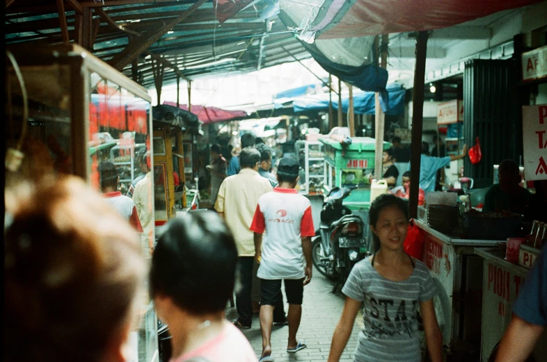 the street with people and carts is crowded