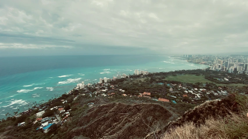 aerial view over the ocean from atop a hill with buildings