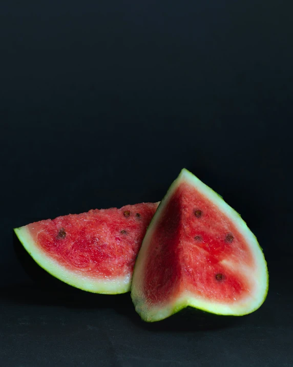 a couple of pieces of watermelon on a table