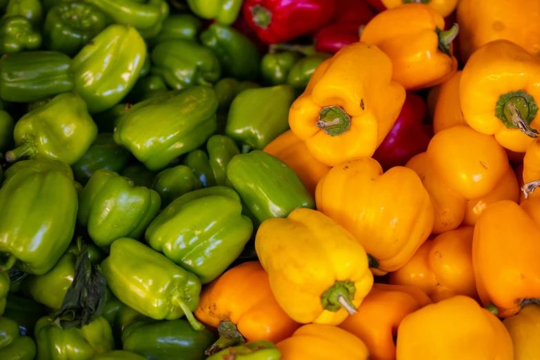 an array of green and yellow peppers, peppers and pepperoni