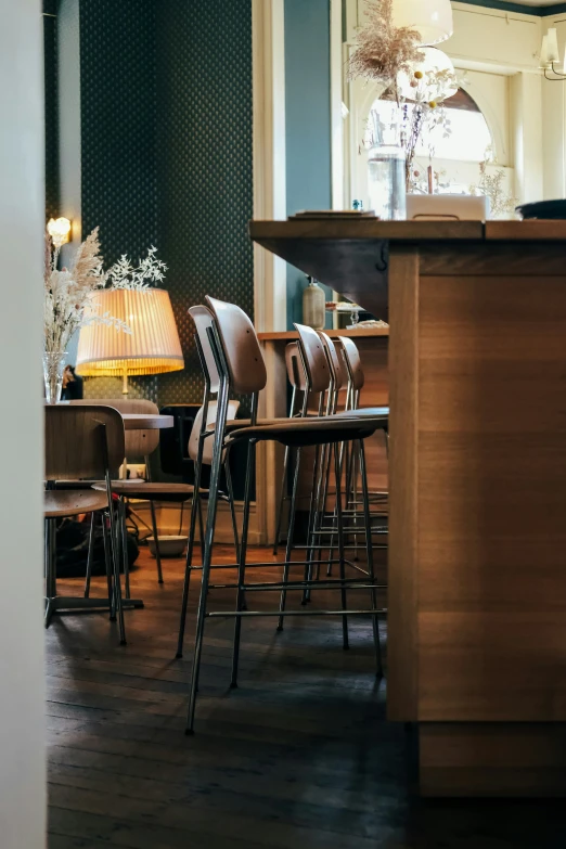 empty chairs and tables in front of a light fixture