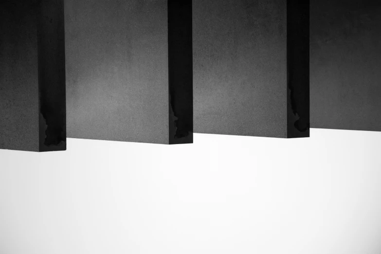 a person standing by three black and white horizontal wall panels