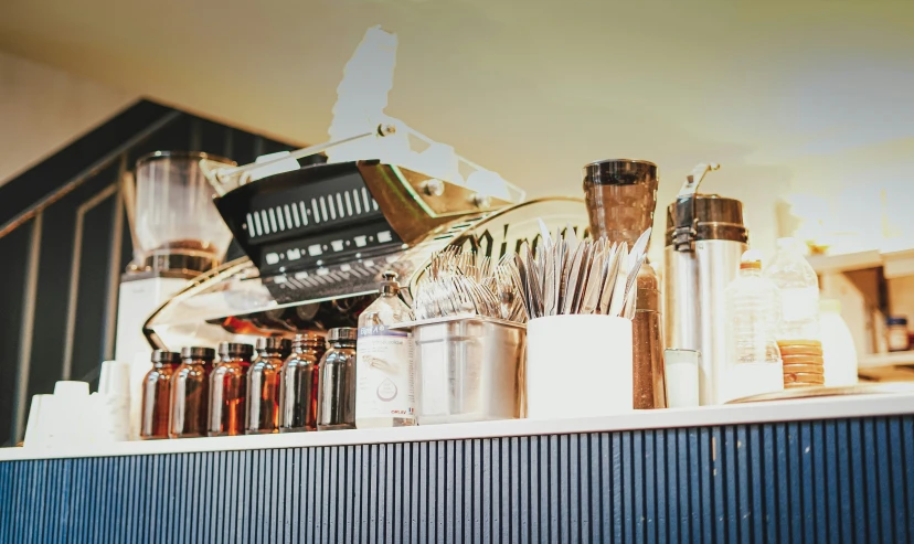 the bottles are on the wall near the hair dryer