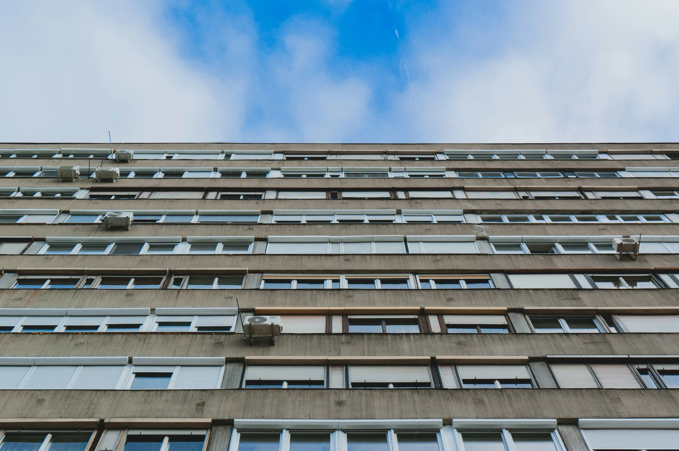 a tall building has many windows with small windows