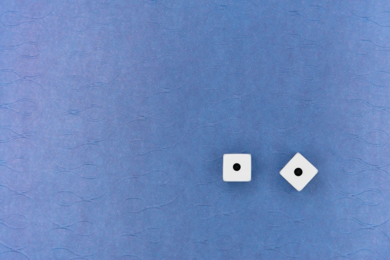 two white dices on a blue background