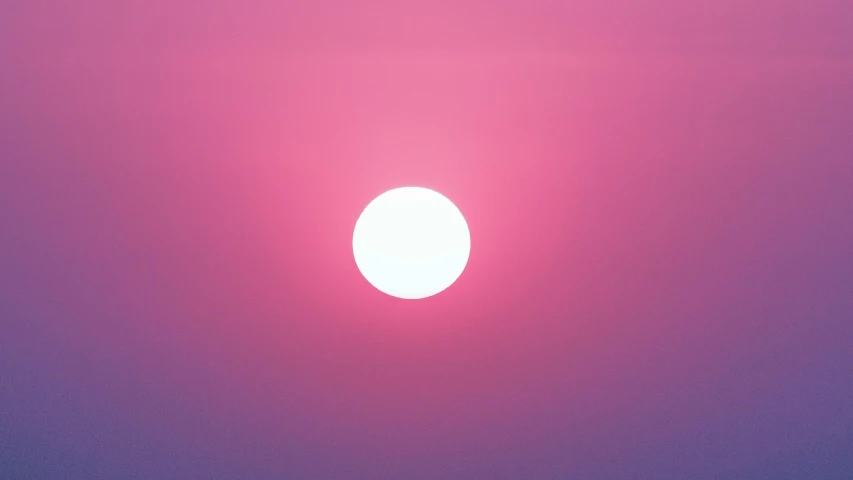 the sun is shown in a large pink sky