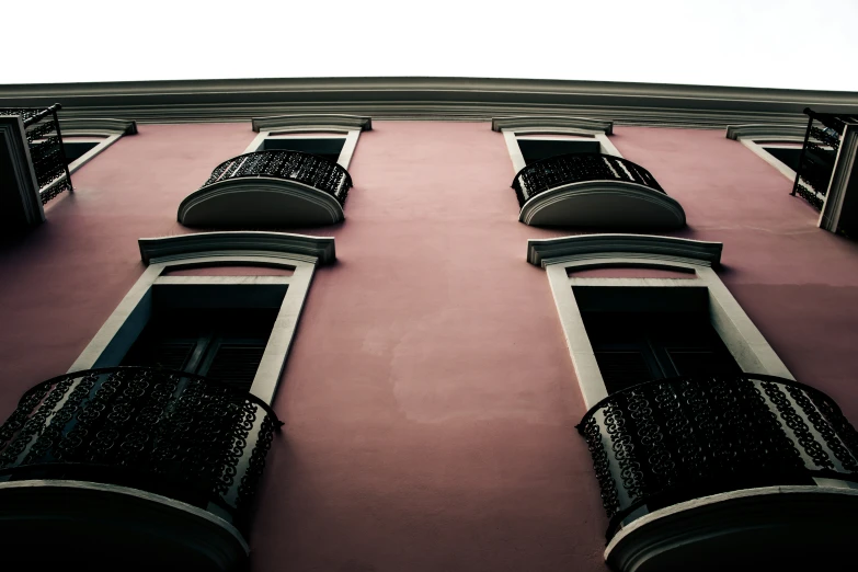 a building with two balconies on it and a clock