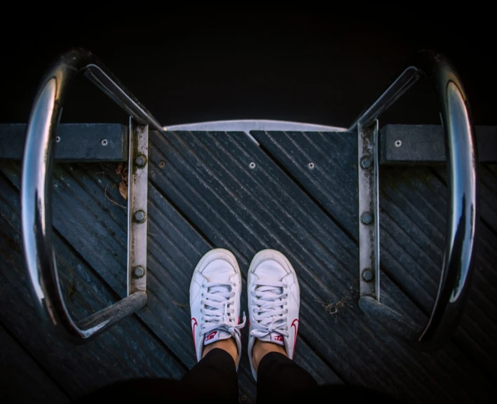 a person standing with white sneakers on