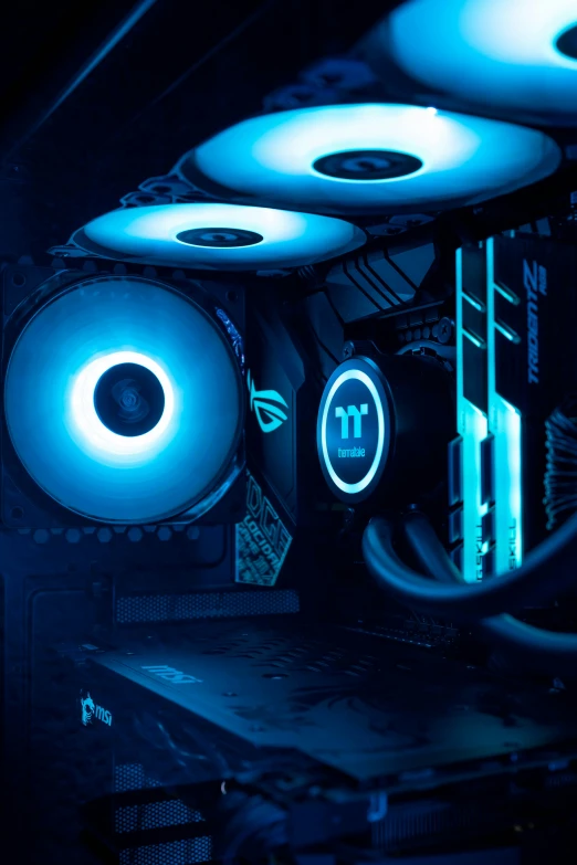 multiple blue lights shine on the outer part of a computer