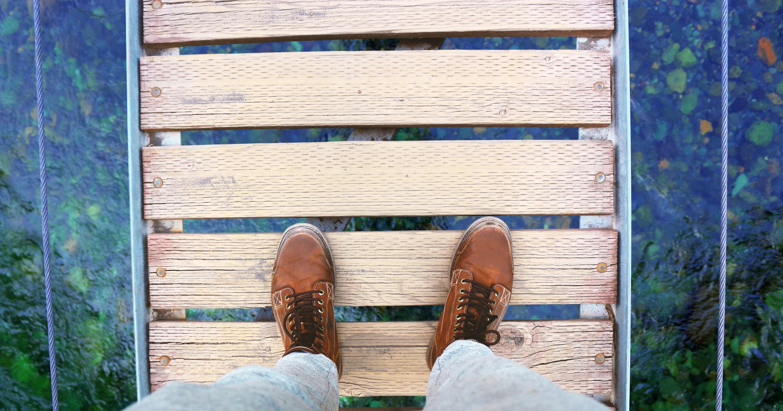 the man is standing on a wooden platform that holds a green and blue background