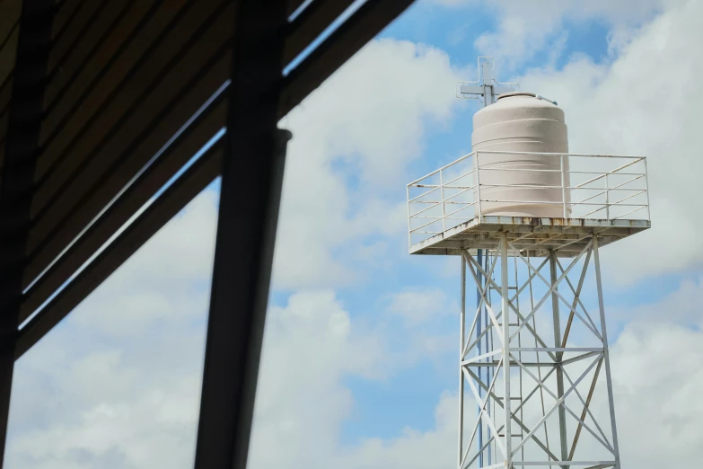 a large water tower with the weather vane