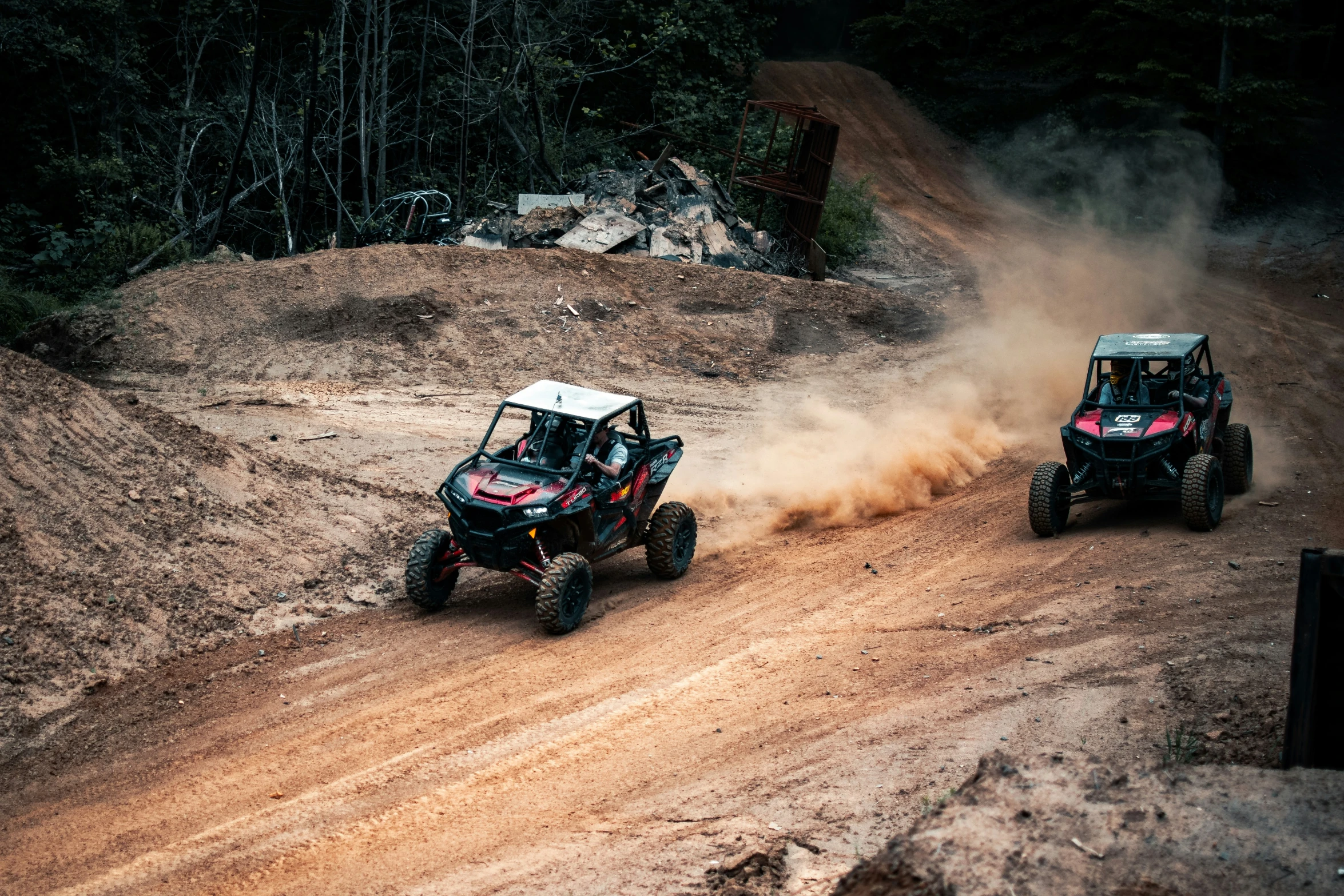 two can - am's racing on muddy roads in the wild