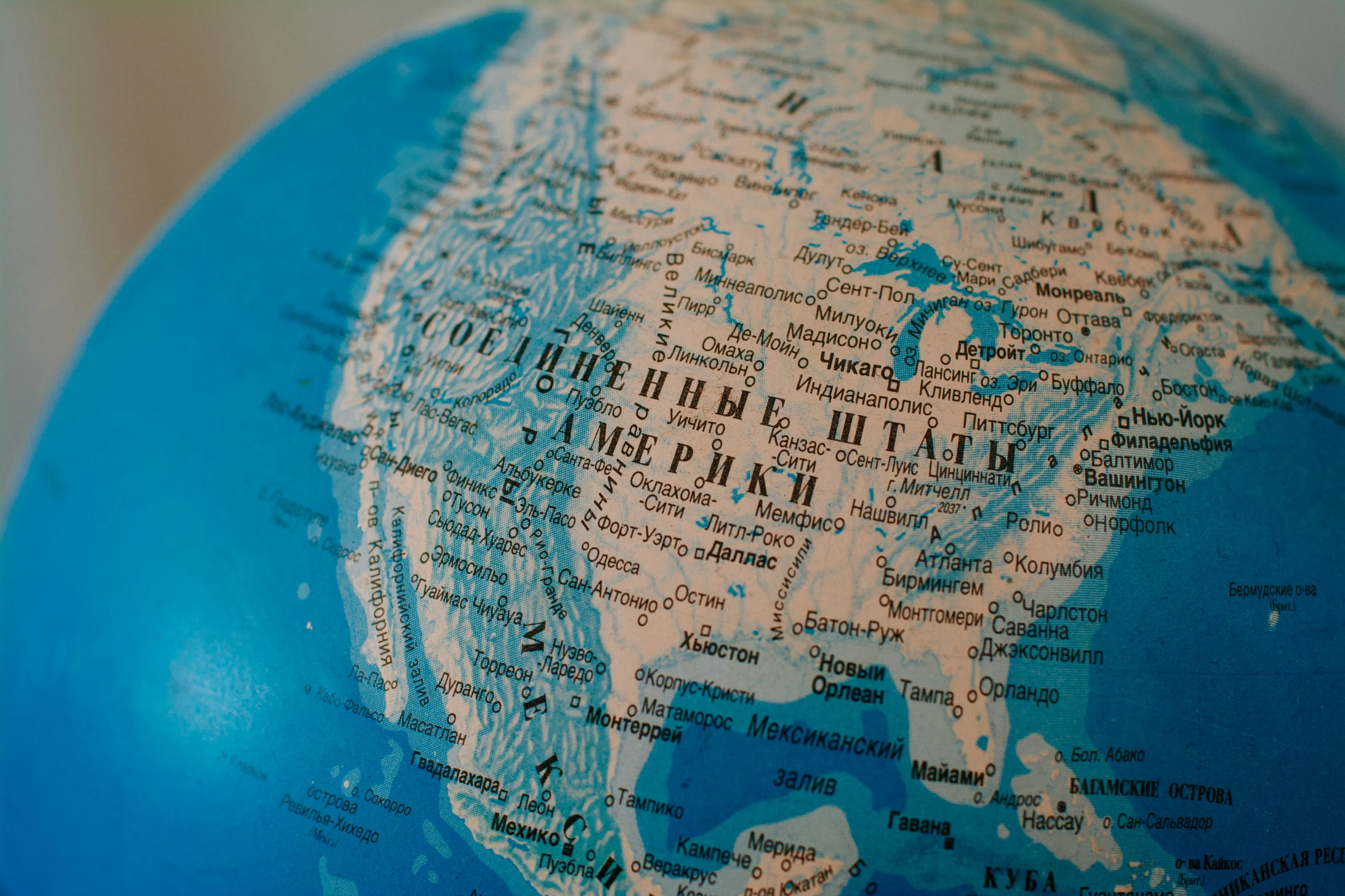 the globe is covered with many names in blue