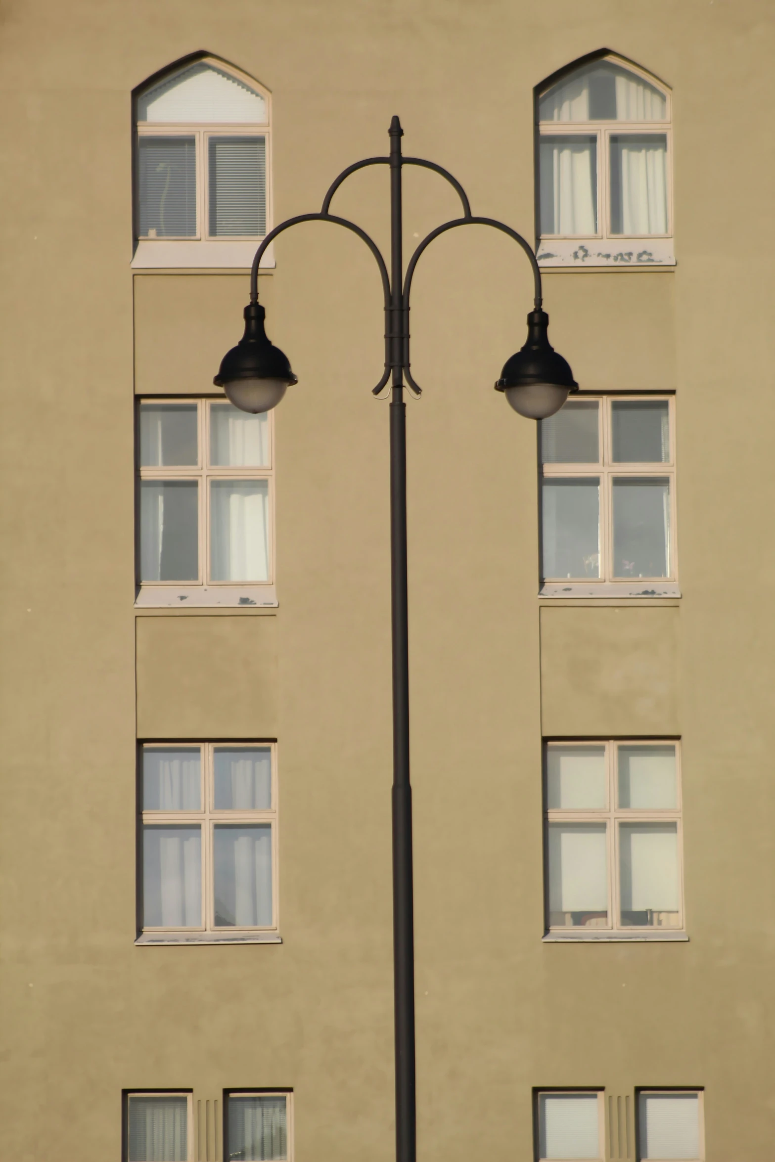 the light is near the windows and is on the pole