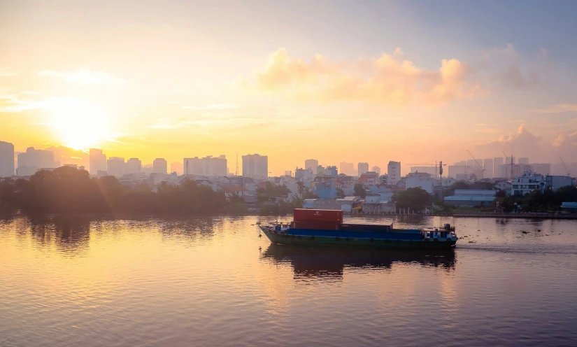 a boat is on the lake with many buildings in the background