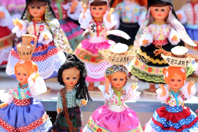 several small dolls in traditional german outfits on display