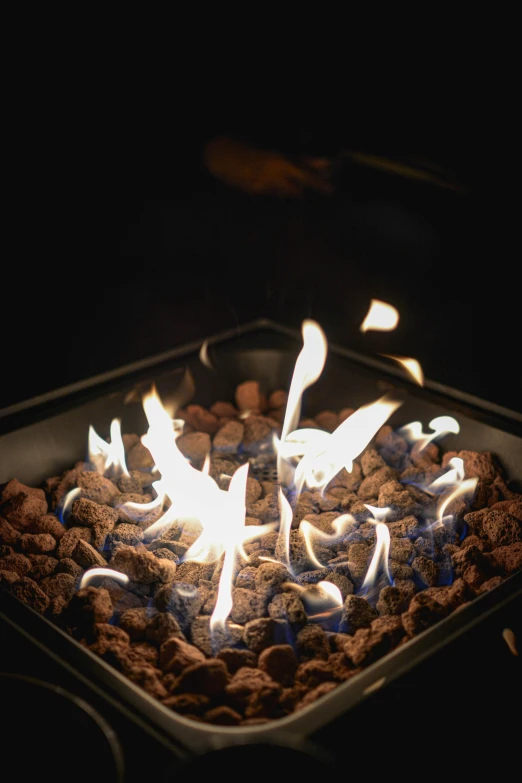 fire flames in a large metal container of food