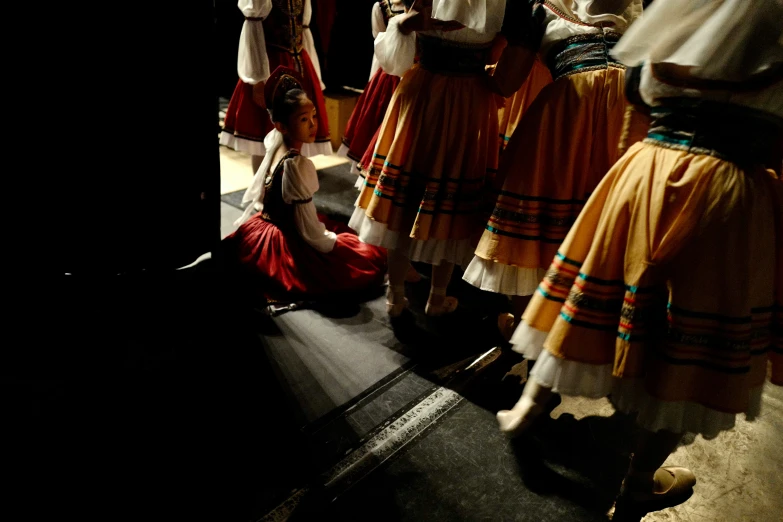 mens clothing are sitting in the dark behind mannequins