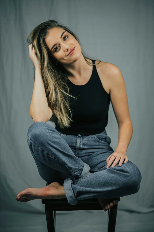 a girl sitting on a chair smiling for the camera