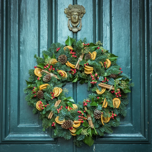 a green wreath with yellow and red decorations