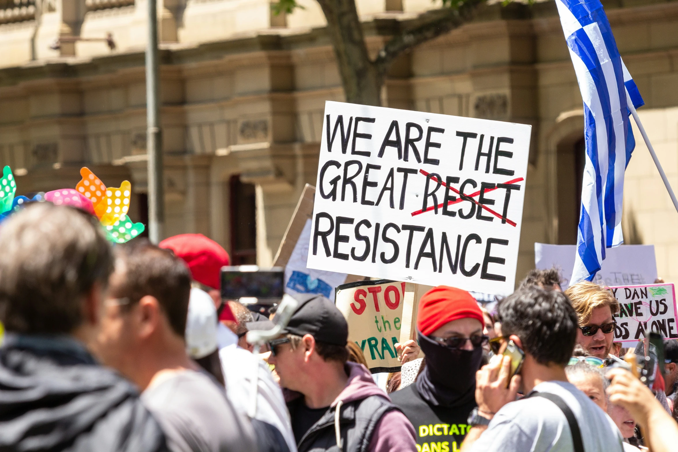 people are holding up signs with writing on them