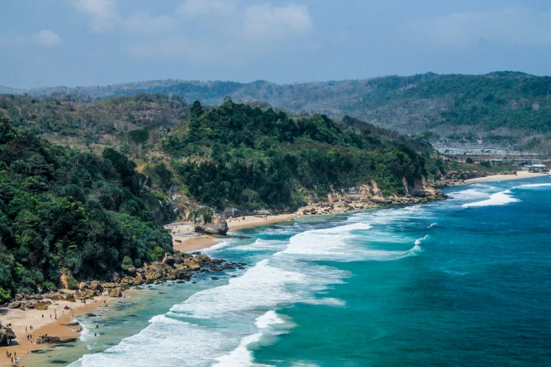 a beautiful beach is lined with trees and water