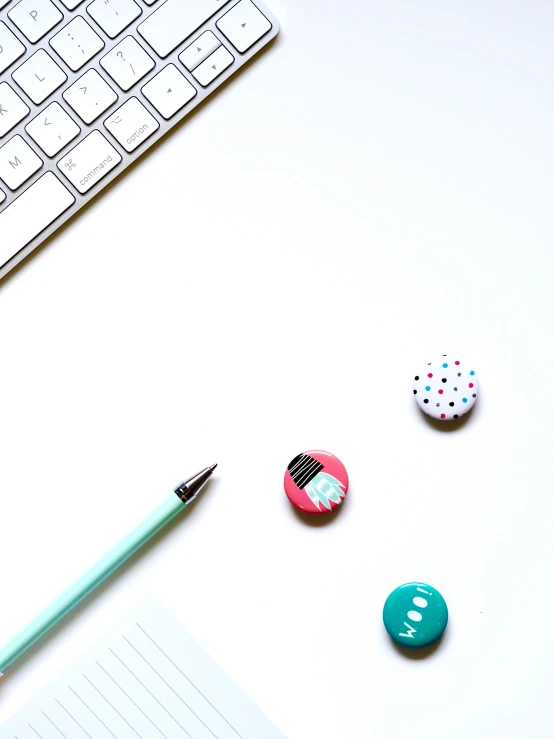 two on badges one for a keyboard, one for a pencil