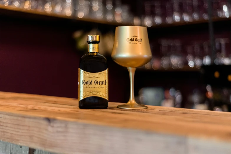 a bottle and wine glass on a wooden table