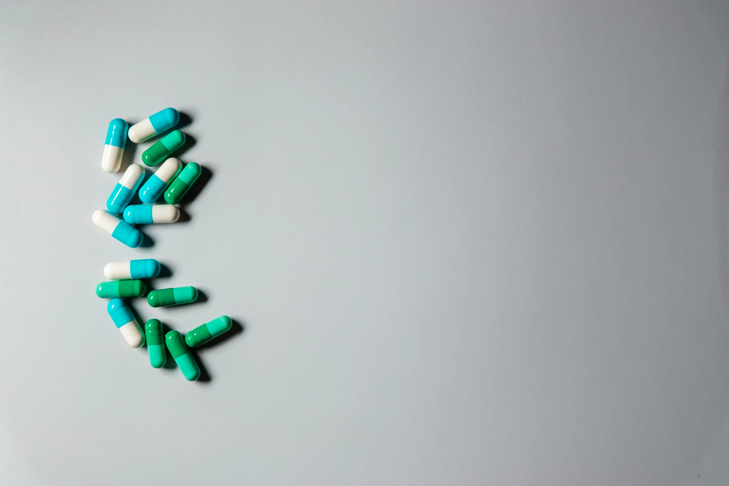 green and white pills on a table