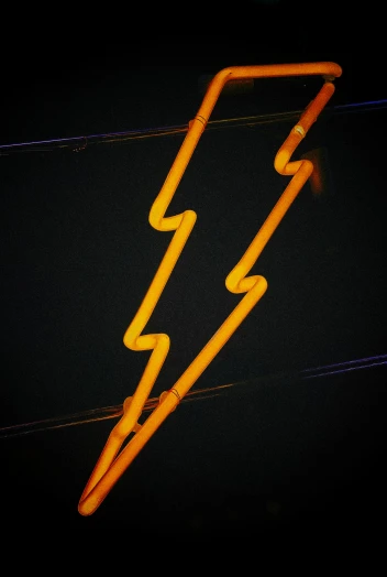 a neon sign in the middle of some wires