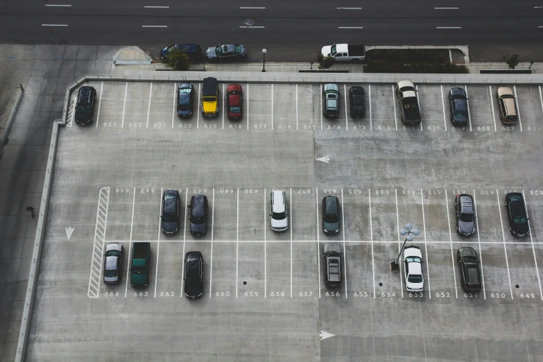 a parking lot with several rows of parked cars