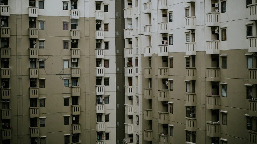 tall beige buildings with lots of windows in them