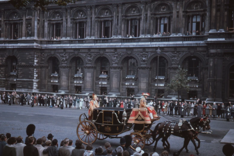 there is a carriage carrying some people down the street