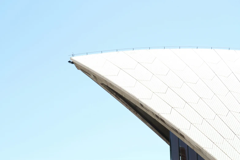 the underside view of a white structure with a long roof