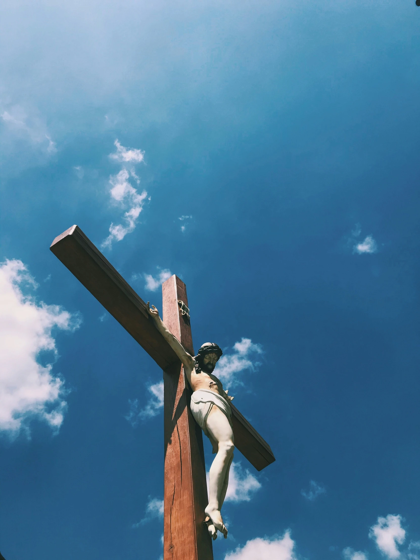 a person on top of a wooden cross