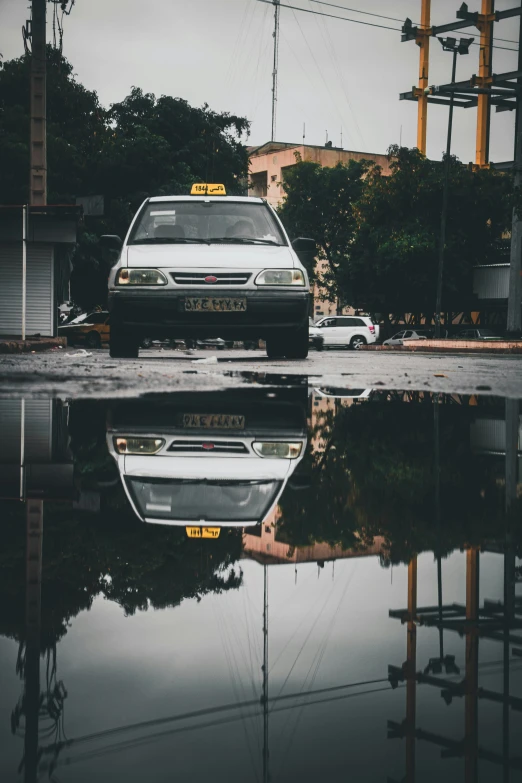 a car parked in the street in the rain