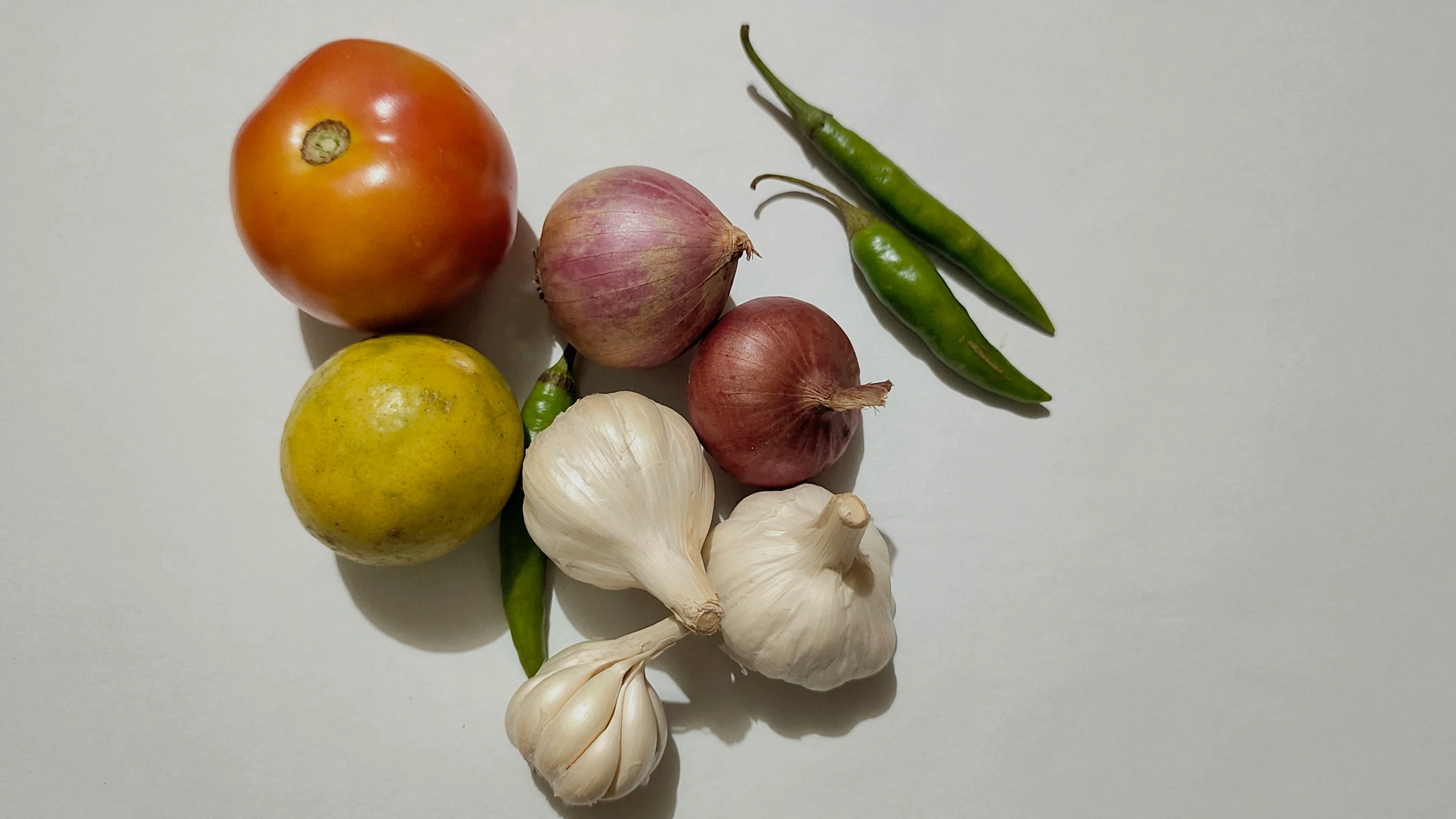 a group of fruits and vegetables sitting next to each other