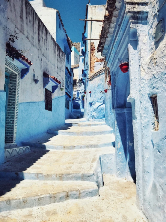 many blue buildings and some steps lead down them