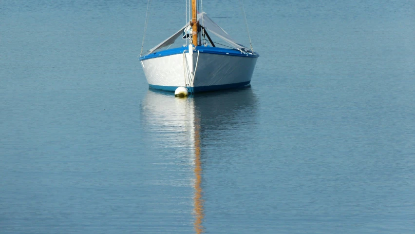 a small boat on the still waters of a lake